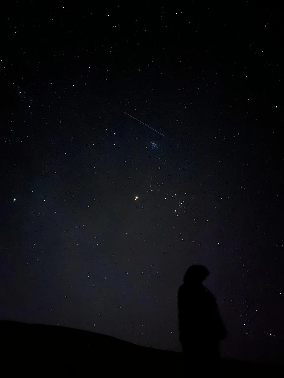 A distant silhouette beneath the stars